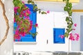 Blooming bougainvillea flowers and blue windows at Koufonisia Cyclades Greece Royalty Free Stock Photo