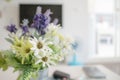 Blooming of fake flower and green leaf on the table