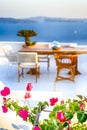 Blooming Flowers at Romantic Open Air Cosy Terrace Restaurant in Beautiful Oia Village on Santorini Island in Greece Before the Royalty Free Stock Photo