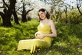 Blooming garden, Beautiful pregnant woman Royalty Free Stock Photo