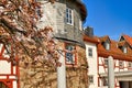 Blooming Japanese cherry blossom trees at old historic square with tower and city wall of Hofheim Royalty Free Stock Photo