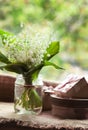 Blooming lily of the valley flowers in glass with