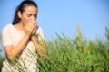 Blooming ragweed plant Ambrosia genus and blurred woman on background. Seasonal allergy