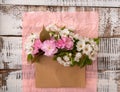 Blooming sakura and white cherry tree. Envelope with spring flowers over pink crumpled decorative paper background.