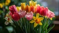 Blooming tulips, daffodils, and Easter lilies in a vibrant springtime arrangement