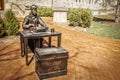 Bloomington USA Bronze statue of historic US miliary man with typewriter and Army chest and google sitting in on campus