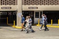 Bloomington USA Group of university students with face masks walk on sidewalk by parking garage near IU campus on sunny