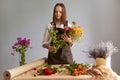 Blossom-filled workplace. Assorted bouquet selection. Professional florist skills. Brunette woman creating beautiful bouquet at