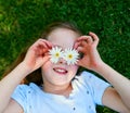 The blossoming beauty of nature. Cropped shot of a little girl covering her eyes with flowers while playing outside. Royalty Free Stock Photo