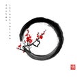 Blossoming branch of oriental sakura cherry in black enso zen circle. Traditional Japanese ink wash painting sumi-e