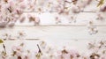 blossoming spring flowers and scattered petals on white rustic wooden texture table top view with copy space