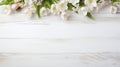 blossoming spring flowers on white rustic wooden table top view with copy space