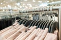 Blouses hang on hangers in the store.