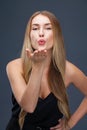 Blow kiss, young caucasian female haired model Royalty Free Stock Photo