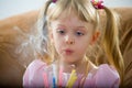 Blowing on a birthday candle Royalty Free Stock Photo