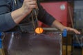 Blowing glass souvenir in glasswork in czechia, human hands make glass produst