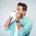 Blowing nose, tissue and man in studio with allergy, sickness and virus infection on white background. Health, wellness Royalty Free Stock Photo