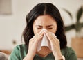Blowing nose, tissue and woman in a living room with flu, cold and hay fever, crisis or viral infection in her home Royalty Free Stock Photo