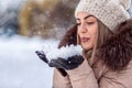 Blowing snow - beautiful girl blowing magic snow. Christmas magi