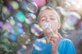 Blowing soap bubbles in the summer sun Royalty Free Stock Photo