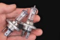 Blown bulbs on a male hand for a passenger car. Replaceable car accessories for headlights Royalty Free Stock Photo