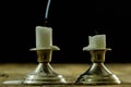 Blown candles in silver candlesticks with smoked wick. Smoke fro Royalty Free Stock Photo
