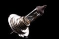 Blown car light bulb on a dark table. Spare parts for passenger cars Royalty Free Stock Photo