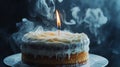 Blown-out candle on frosted cake with smoke trail . Royalty Free Stock Photo