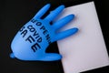 Blown up blue latex surgical glove on black background. Reopening covid safe. Open again text written on medical glove. New normal