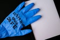 Blown up blue latex surgical glove on black background. Reopening covid safe. Open again text written on medical glove. New normal