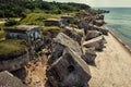 Blown up german military forts on the beach under blue sky drone photo