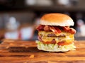 BLT cheeseburger on wooden table