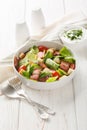 BLT salad is loaded with fresh lettuce, crispy bacon, bright tomatoes croutons closeup on the plate. Vertical Royalty Free Stock Photo