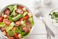 BLT salad with romaine lettuce, pieces of crispy bacon, tomatoes, crunchy croutons, and a creamy garlic dressing closeup on the Royalty Free Stock Photo