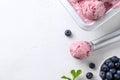 Bluberry ice cream ball in scoop on white background. Close up. Space for text Royalty Free Stock Photo