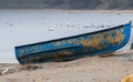 A blue abandoned boat at the sea shore Royalty Free Stock Photo