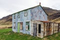 Blue abandoned and rusty farmhouse. Near Djupivogur in Iceland next to the ring road during road trip.