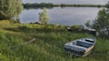 Blue abandoned small boat on the Bank of the river Royalty Free Stock Photo