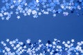 Blue abstract Christmas background border, frame texture with stars confetti on blue background. Space for text Royalty Free Stock Photo