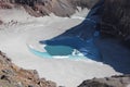 Blue acid lake in the east crater of Gorely volcano, covered with floating ice, Kamchatka Peninsula Royalty Free Stock Photo