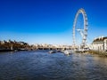 Blue aerial sky sunny day in the city of London ferry wheel London eye next river thames bridge pier ferrys boat clouds