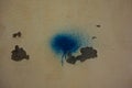 blue aerosol splodge with background peeling white paint