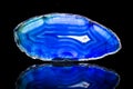 Blue agate slice, black background, healing stone and mineral Royalty Free Stock Photo