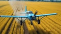 Blue agricultural aircraft plane watering a field during the daytime
