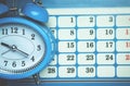 Blue alarm clock with calendar. Business concept