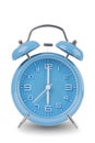 Blue alarm clock with the hands at 6 am or pm isolated on a white background