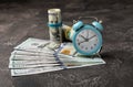 Blue alarm clock on money banknotes Dollars, business planning and finance concept. Royalty Free Stock Photo