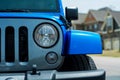 Blue all terrain vehicle parked in neighborhood.