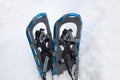 Blue aluminum snowshoes in a snowbank Royalty Free Stock Photo