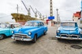 Blue american classic cars and rusty ship, Santiago de Cuba